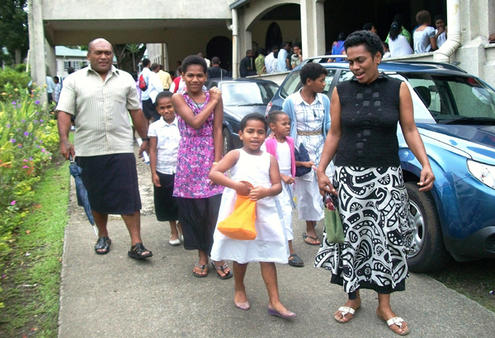 For their sake: 4. A family emerges from the cathedral after Sunday's 'No to violence' service.