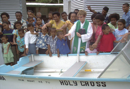 Rev Marie Gilpin blesses a rowboat destined for Vanua Levu.