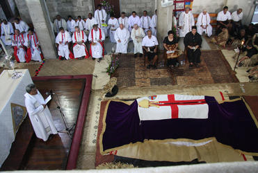 The President of Fiji and his wife and Prince Tungi of Tonga are seated opposite the casket. Dean Fereimi Cama is speaking.
