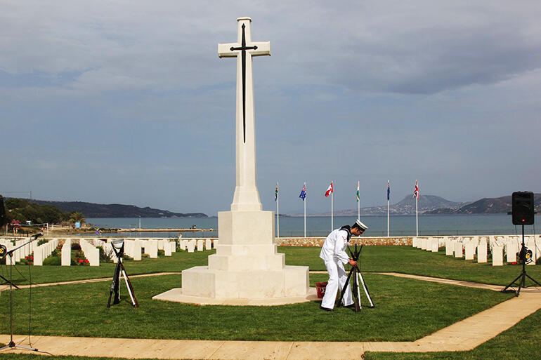 A Greek sailor makes final preparations for the service of remembrance at the Souda Bay War Cemetery.