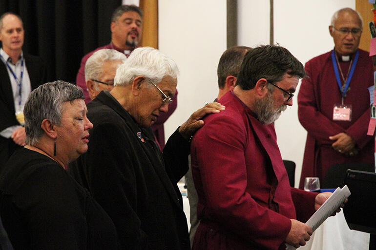 The Archdeacon extends his hand to Archbishop Philip during his solemn reading of the church's apology to Tauranga Iwi at the 2018 General Synod. The Archdeacon extends his hand to Archbishop Philip during his solemn reading of the church's apology to Tauranga Iwi at the 2018 General Synod.