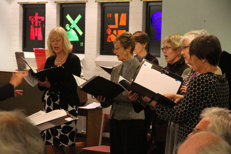Members of the French music choir directed by Mark Dorrell sing at the Home of Compassion chapel mass.