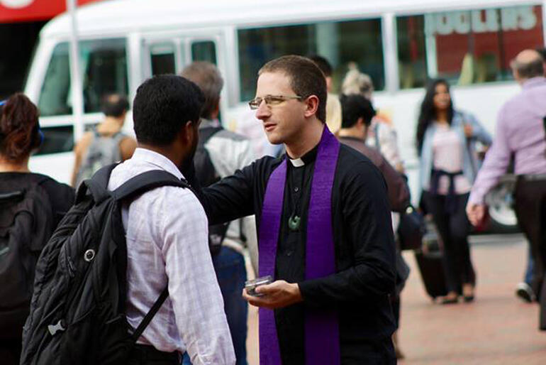 Rev Scottie Reeve marks the sign of the cross