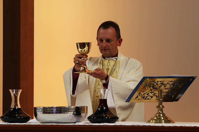 Bishop Ross Bay elevates the chalice during The Great Thanksgiving.