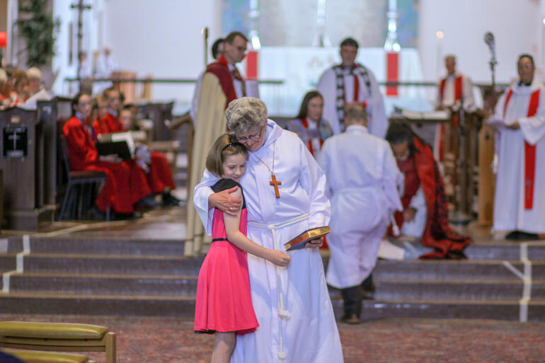 New deacon Rev Wendy Thornburrow, who works in hospital chaplaincy in Masterton, receives a hug from a friend. 