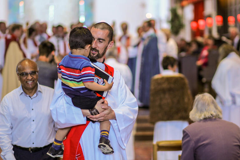 On the way to being priested, Rev Paul Fletcher of Urban Vision picks up his son Ishmael.