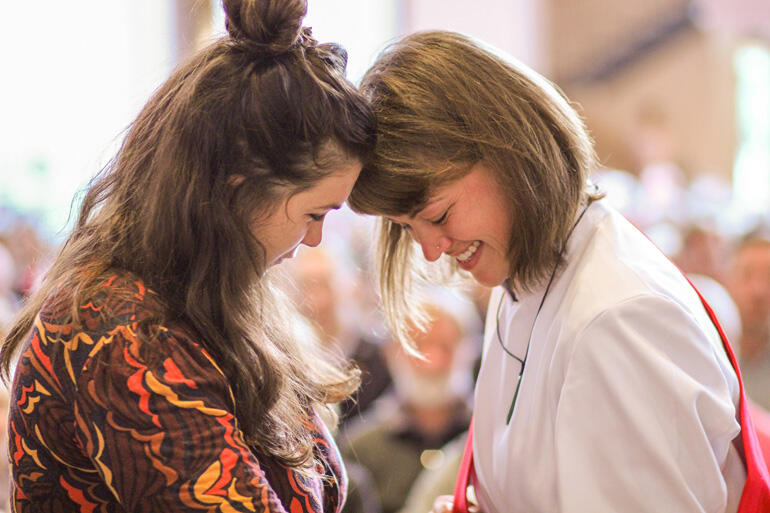 Rev Chelsea Kirby, who serves with Urban Vision in Whanganui, shares a moment with a supporter during her diaconal ordination.