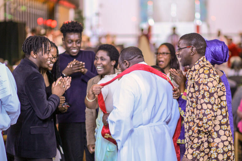 Rev Froduald Mugiraneza from Journey Christian Fellowship at St Paul’s Waiwhetu shares a light moment with supporters as he joins the diaconate.