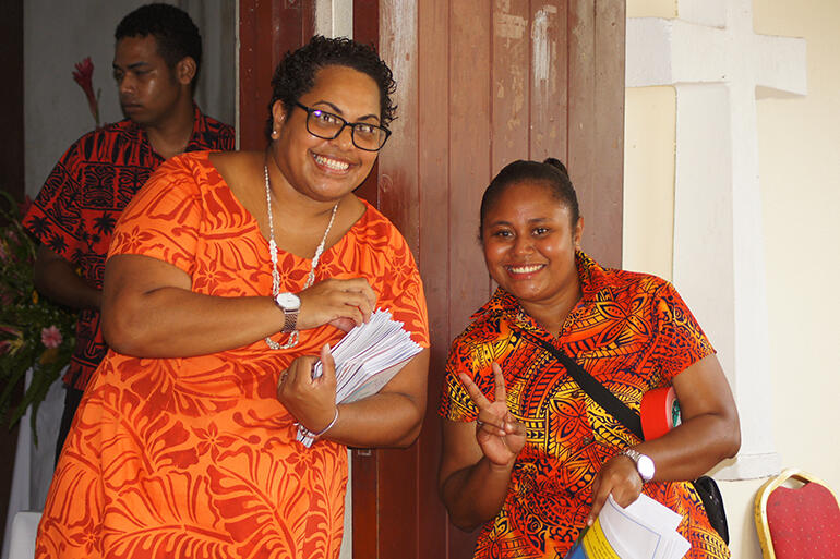 Welcome! Miriama Naulumatua (in the orange dress) and Lipo Marama greet visitors to the cathedral.