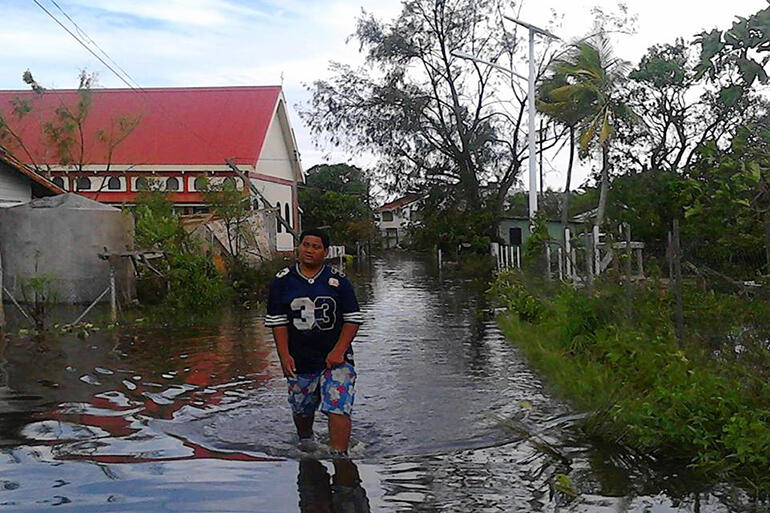 Wading down the footpath past All Saint's Fasi. Pic by Malu Elone.