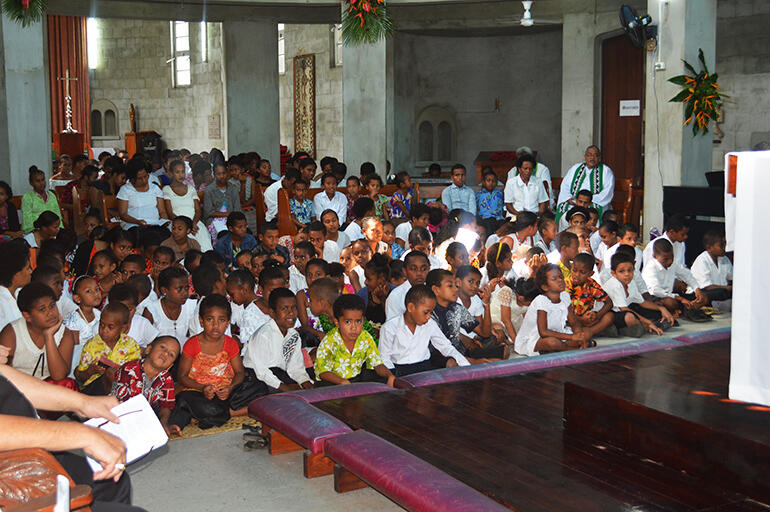The children gathered behind the altar. The children gathered behind the altar.