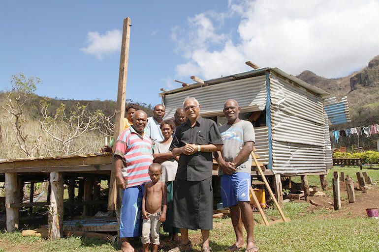 Flashback to March 2016: Archbishop Winston and Mosese Kakaramu outside what was left of his home. Flashback to March 2016: Archbishop Winston and Mosese Kakaramu outside what was left of his home.