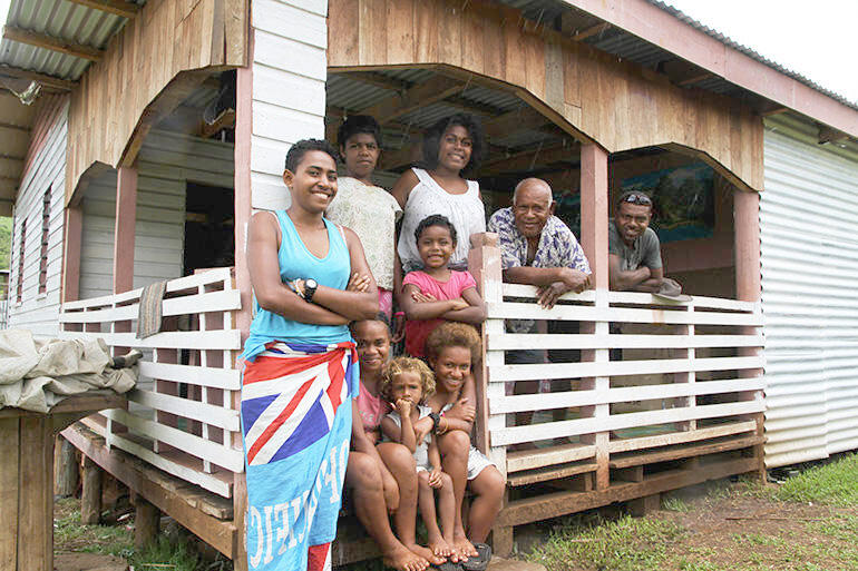 Home sweet home: Mosese Kakaramu and his broader family outside their new home.