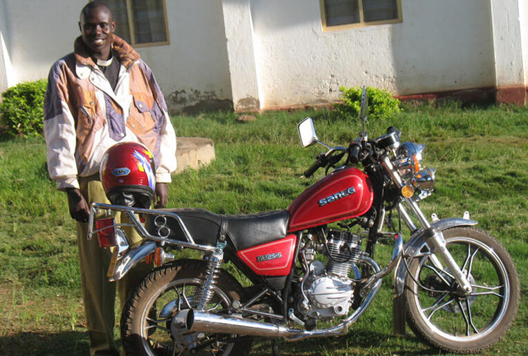 Rev Paulo Ryoba with his motor-cycle in the diocese of Tarime.