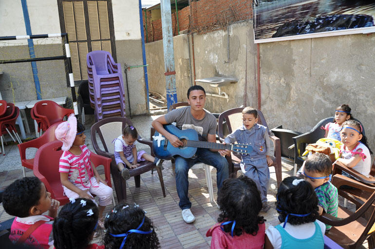 Young worshippers lift their voices in song outside the Church of the Epiphany in Port Said.