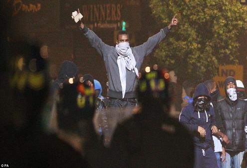 Masked youths defy police in Tottenham. 