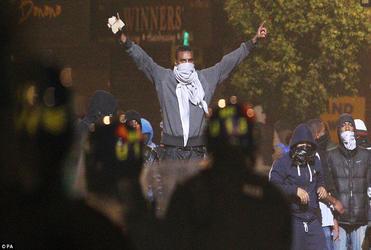 Masked youths defy police in Tottenham. 