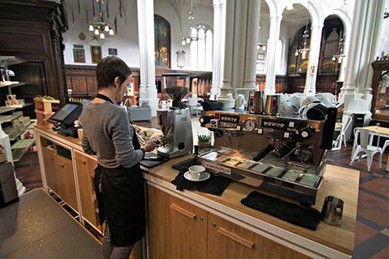 Barista gets ready at the Host café at St Mary Aldermary, London.The café is a fresh expression run by Moot, a new-monastic community.