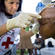 Canadian Red Cross nurse Suzanne Puzo removes bandages from Danise Diverge, 10, in Croix Desprez, Port-au-Prince.