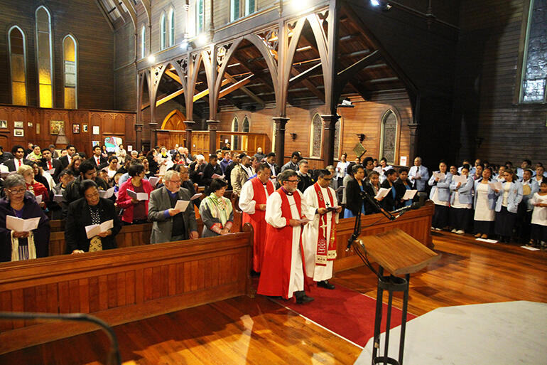 The service begins. That's Archbishop Philip alongside the Rev Prince Devanandan, followed by Bishop Kito Pikaahu.