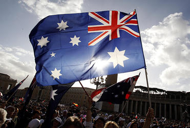 Australian pilgrims brandish their flag at the canonisation of Mary MacKillop.
