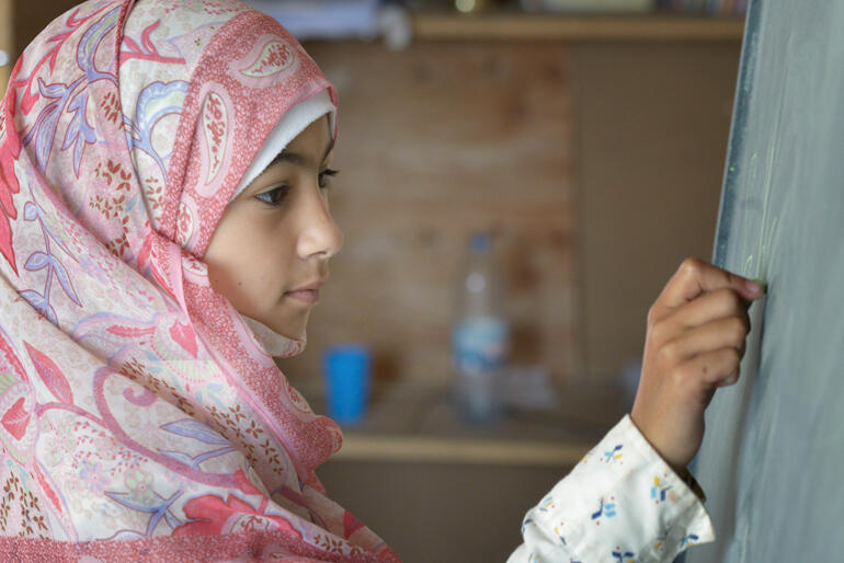 A Syrian refugee student works in a DSPR run school in Lebanon. Photo: Action of Churches Together (ACT) / Paul Jeffrey