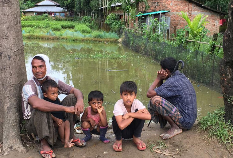 Rohingya men supervise children in one of the flood-stricken areas where aid agencies are working to provide food and shelter. Photo:Christian Aid. Rohingya men supervise children in one of the flood-stricken areas where aid agencies are working to provide food and shelter. Photo:Christian Aid.