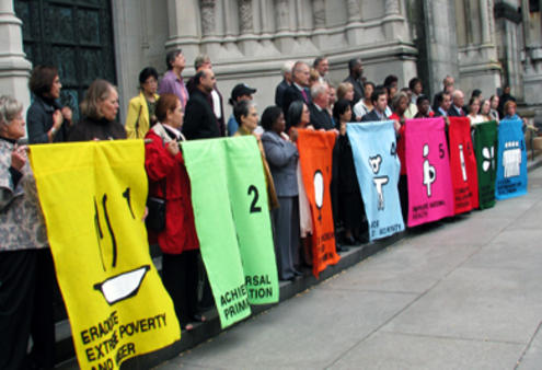 Rally participants highlight the MDGs on the steps of St John the Divine in New York.