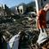 Brother Joseph Brown walks through the rubble of his monastery after it was levelled by fire. Picture, Los Angeles Times.