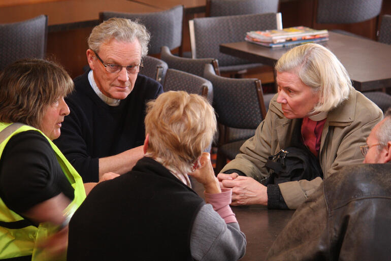 The Anglican team comparing Kaiapoi notes with a Salvation Army worker The Anglican team comparing Kaiapoi notes with a Salvation Army worker
