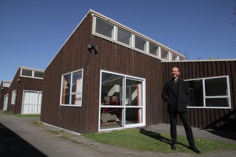 Vicar of Dunedin North Rev Canon Michael Wallace stands outside the three flats the parish has shifted into social housing.