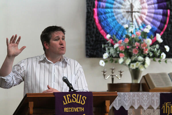 The Rev Jay Behan, Vicar of St Stephen's Shirley, preaching on hope to his congregation, which is meeting in a borrowed church.