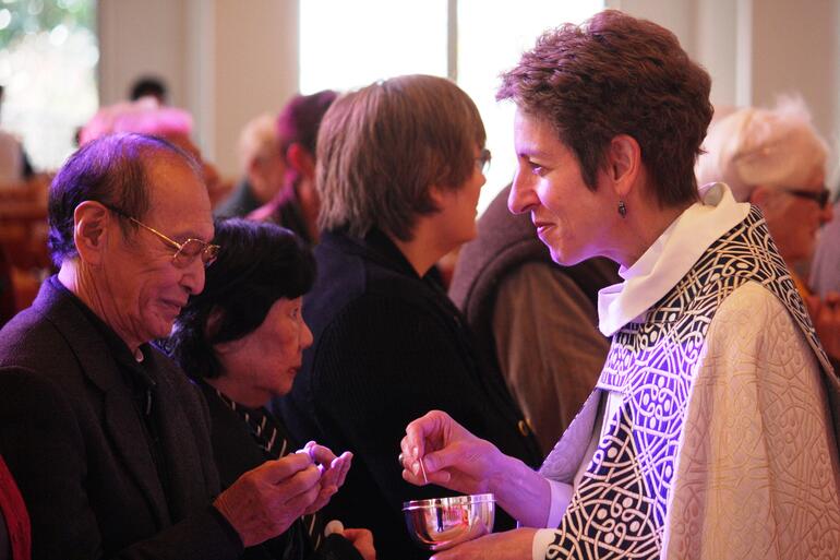 Bishop Katharine serves the Host at yesterday's Eucharist at the Parnell cathedral.