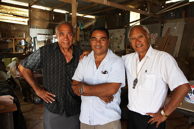 Archdeacon Joe Le'ota, left, and Archbishop Winston Halapua flank Tevita Hikila, who owns the workshop where the furniture was finished.