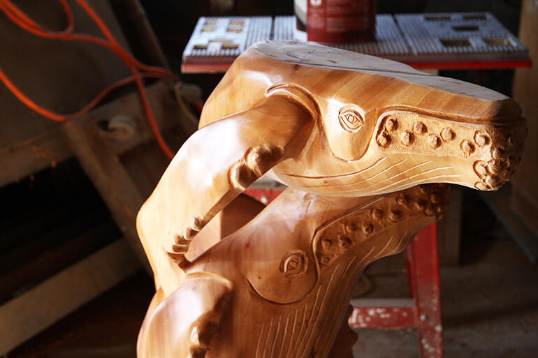 This mother and baby whale hold up one side of the altar, which rests on the young whale's head.