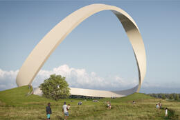 A huge white eternity loop made of white bricks stands in an English countryside scene