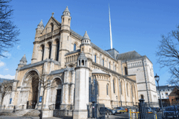 A 19th century stone Cathedral rises up against the sky