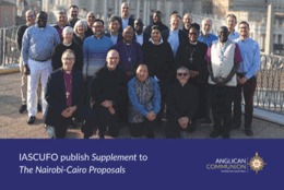 Globally diverse group of priests and lay theologians smile for a group photo