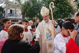Cardinal Pizzaballa shakes the hand of a parishioner outside the Catholic church in Gaza