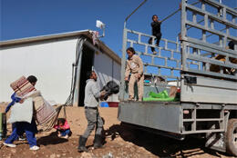 A Palestinian family loads household goods as they are illegally forced out of their West Bank home