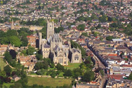 Ely Cathedral stands in its grassy grounds in its 19th century UK town.