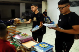 Two Palestinian teens look at the new textbooks that omit Palestinian history