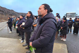 A group of Ngāti Rangi members pause for karakia facing Mount Ruapehu 