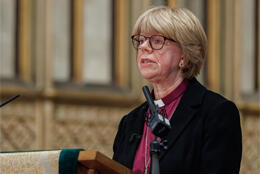 Sarah Mullally looks to the right from a podium