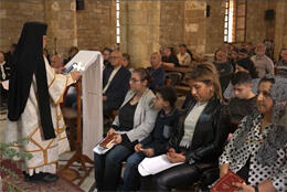A black-veiled Greek Melkite Catholic priest leads a service in Tyre in Lebanon
