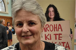 Two women attend a public rally and seminar