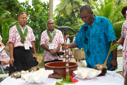 A group of pacific church leaders join Togoru community rep Barney Dunn around a cross and kava bowl 