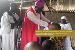 A bishop confirms a line of people in an earth-walled, tin-roofed building