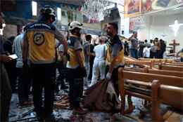 Emergency teams work inside a bombed Syrian Orthodox church