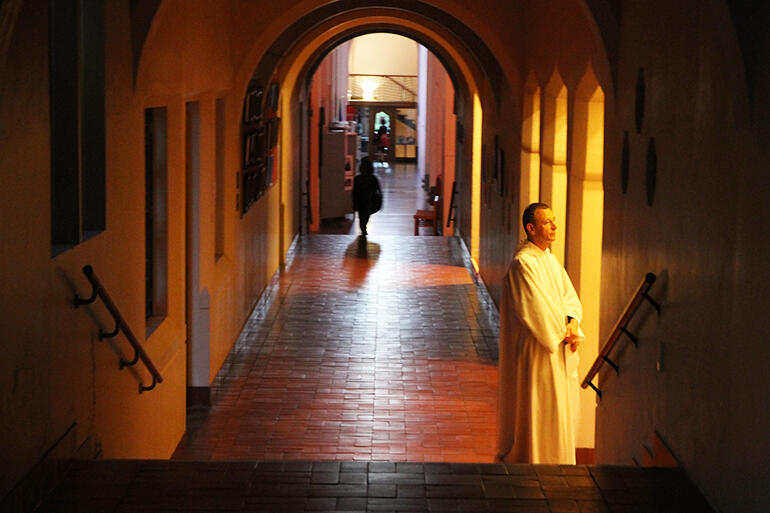 Monastic moment. Brother Alois, the Prior of the Taize community, waits to enter the cathedral.
